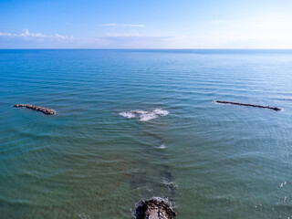Aerial view landscape Italy Pescara. Sea, waves, breakwater, stones, rocks, beach, sand, empty.