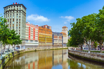 Obraz premium High apartment buildings along the Nervion River, Bilbao, Spain. Nervion river embankment in Bilbao.
