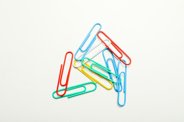 Concept of different office accessories - clips on white background