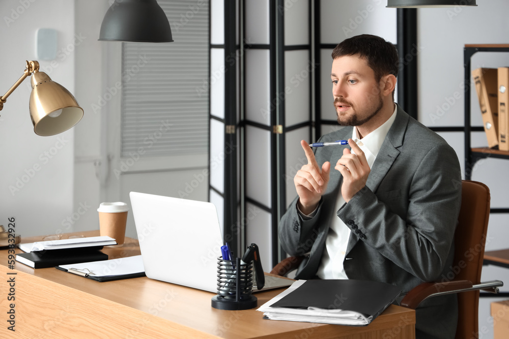 Poster Male tutor with pen giving online lesson at home