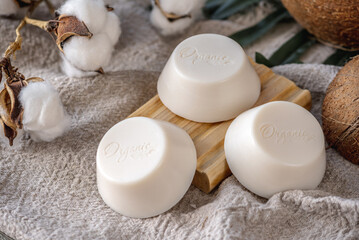 Fototapeta na wymiar Pieces of white natural soap with the inscription Organic and soap dish on the table