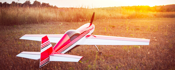 Naklejka premium airplane model on the runway at sunset