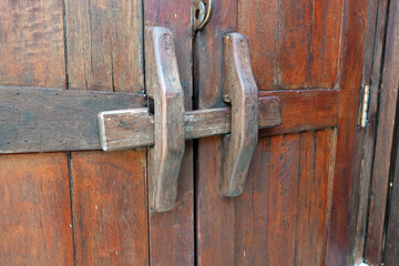 handmade wooden lock or ancient door latch. 
Thailand traditional wood door  