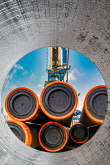 Pipes for a well close-up. Powerful drilling rig against a cloudy sky. Drilling of deep wells....