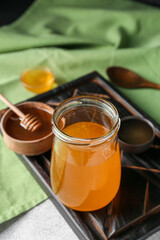 Jar of sweet honey on table