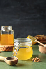 Jars of sweet honey on table