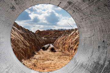 Insulated pipe. Large metal pipes with a plastic sheath laid in a trench. Modern pipeline for...