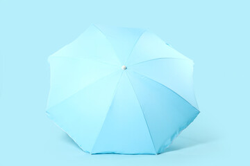 Beach umbrella on blue background