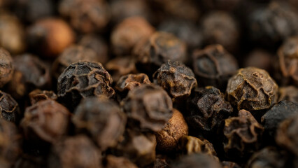 Whole black peppercorns macro. Dried black peppers. Seasonings and condiments concept