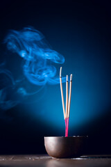 Incense sticks and incense stick smoke on black backgrond with white backlit