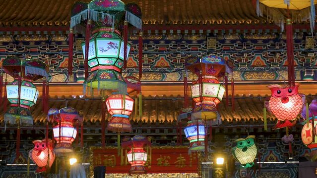 Chinese lanterns, which symbolize prosperity and good fortune, hang from ceiling wires next to a temple during the Mid-Autumn Festival, also called Mooncake Festival.