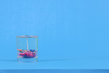 candle.Paste on blue background with copy space for design.