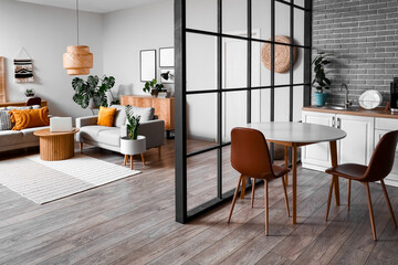 Interior of studio apartment with sofas and dining table