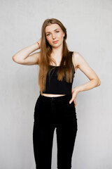 Casual portrait of cute girl in sleveless t-shirt and tight jeans