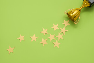 Gold cup with stars on green background