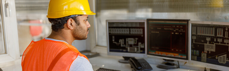 Young multiethnic operator working at concrete plant