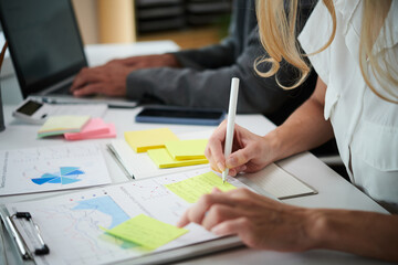 Financial analysts working with reports, preparing for meeting