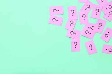 Papers with question marks on green background