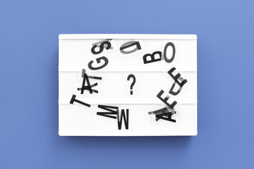 Board with question mark and letters on blue background