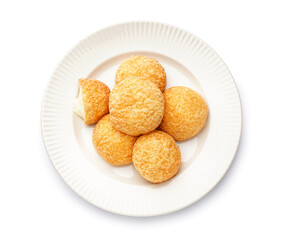 Plate with delicious choux pastry on white background