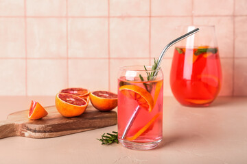 Glass of tasty blood orange lemonade on table