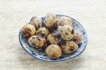 Raw quail eggs heap in the bowl