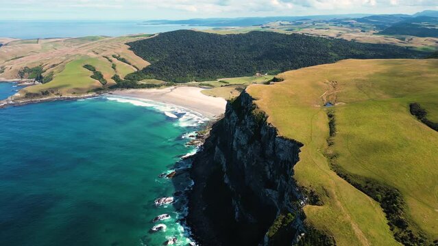 Aerial over Parakanui with sandy beaches and cliffs in the South Island of New Zealand. Drone orbit left to right