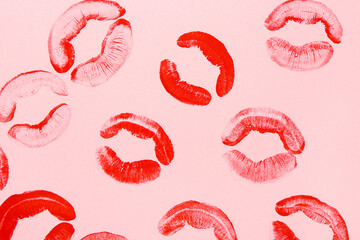 Red lipstick kiss marks on pink background