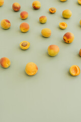 Fototapeta na wymiar Aesthetic fruit background. Ripe juicy peaches on pastel green background. Fresh organic fruit vegan food