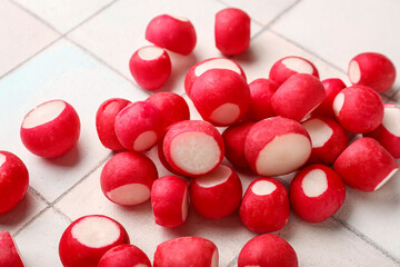 Heap of fresh radish on white tile background