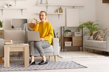 Female student studying online with laptop at home