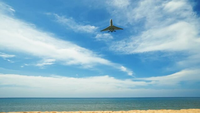 Commercial Airplane Flying in the Blue Sky Over the Sea. Plane is Ready to Landing. Travel concept. Go Everywhere