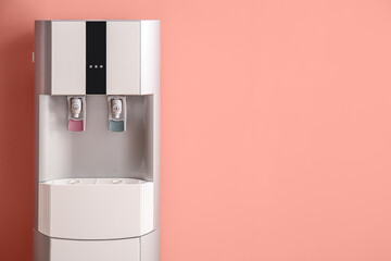 Modern water cooler on coral background