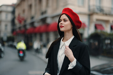 Fashion woman portrait beauty standing on the street in front of the city in stylish clothes with red lips and red beret, travel, cinematic color, retro vintage style, urban fashion lifestyle.