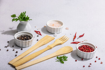 Culinary background with wooden kitchen utensil, spices and herbs. Set for preparation healthy food
