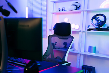 Darkroom for a professional gamer with a comfortable empty gamer chair, computer table, neon...