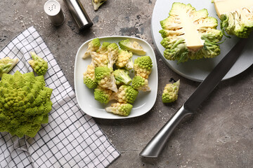Plates with romanesco cabbage on grey grunge background