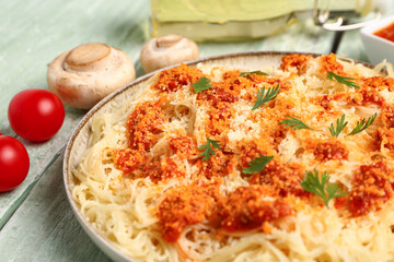 Plate of tasty Italian pasta with Parmesan cheese on table, closeup