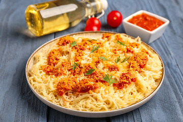 Plate of tasty Italian pasta with Parmesan cheese on wooden background