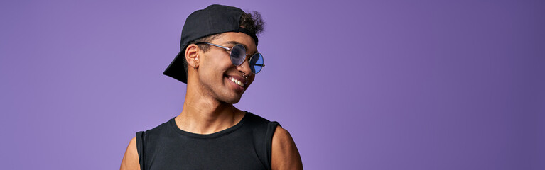 Obraz premium Portrait of transgender male in black t-shirt and blue jeans. Latino trans gender model posing