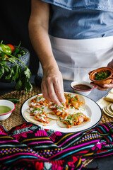 Mexican woman hands preparing tacos al pastor and eating traditional mexican food in Mexico Latin America, hispanic people