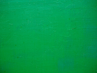 Fototapeta na wymiar Green background texture. Rough surface painted with green paint