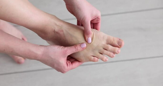 Woman massaging painful leg and foot pain. Foot pain causes, diagnosis and treatment