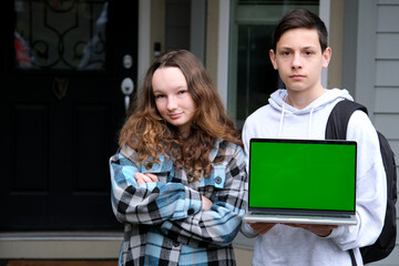 Cool Website. Happy Middle Eastern Couple Pointing At Laptop With White Screen, Young Cheerful Arab Man And Woman Showing Copy Space For Online Advertisement, Posing Over