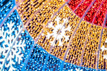 Abstract lights. Christmas street decoration lights, out of focus, in the shape of circles.  Blue, gold and red lights, with black background. Tenerife, Canary Islands, Spain.