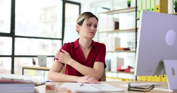 Woman nervously scratches skin of neck in office. Psychogenic itching causes and symptoms