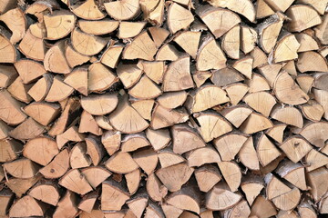 A stack of chopped birch firewood for sauna oven and fireplace. 