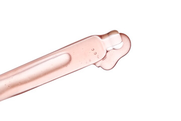 Pipette with a viscous pink cosmetic close-up.