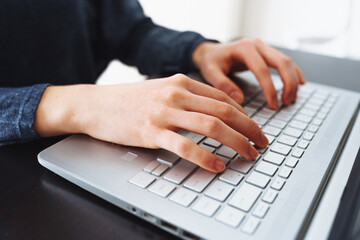 female hands on laptop keyboard