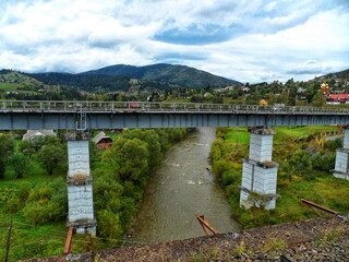 Fototapeta premium Railway bridge across the river in the mountains
